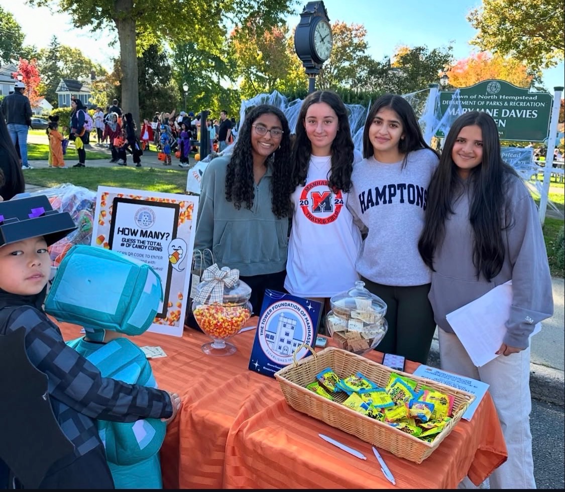 Krisha volunteering with friends at a community event table