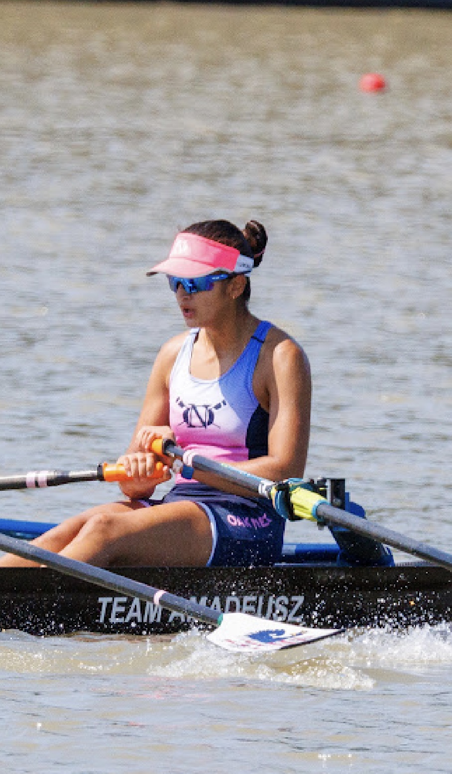 Krisha Wadhwa rowing in a crew shell during a regatta